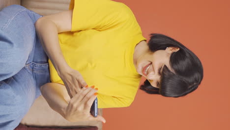 Vertical-video-of-The-young-woman-who-happily-puts-the-phone-to-her-heart.